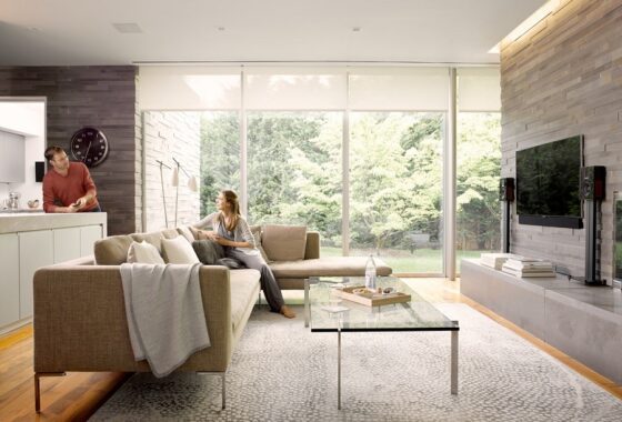 living room with two people showing smart home technology tv