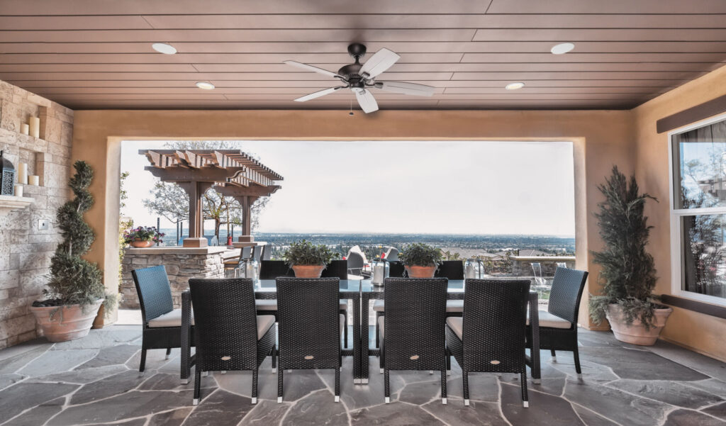 Open-air room overlooking the ocean with Sonance in-ceiling speakers.